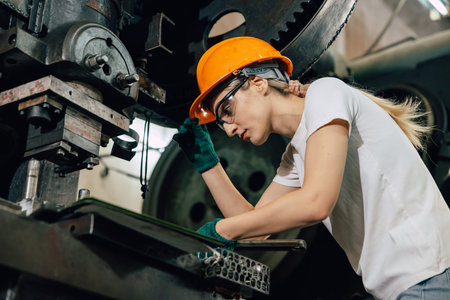 male worker working in heavy metal industry factory fixing service maintenance machine