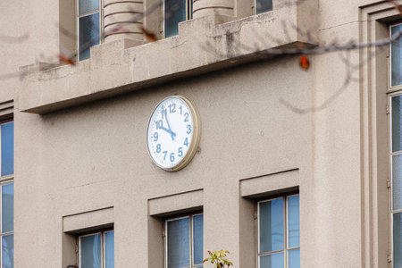high school facade building with time clock at the center in japan traditional style visibleの写真素材