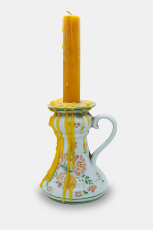 antique candle holder vintage style with handle and candle wax dripping flow down isolated on white background with clipping pathの写真素材