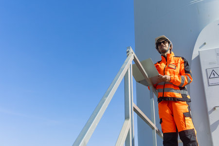 Professional Engineer worker safety working service maintenance wind turbine green power green clean energy system outdoors.の写真素材