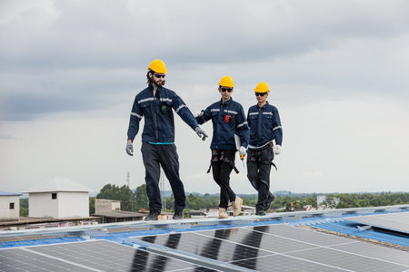 Professional Engineer Service Solar Panel. Worker Maintenance Cleaning Replacing Solar Panel. Solar photovoltaic panel system in Industry roof. Saving Energy with Clean Power.の写真素材