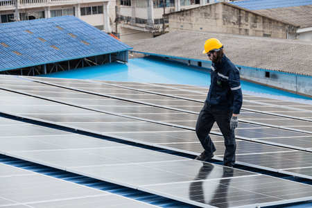 Professional Engineer Service Solar Panel. Worker Maintenance Cleaning Replacing Solar Panel. Solar photovoltaic panel system in Industry roof. Saving Energy with Clean Power.の写真素材