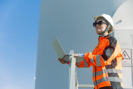 Professional Engineer technician worker checking service maintenance wind turbine clean electricity...