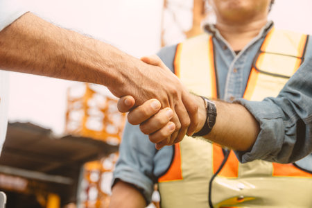 Workers team hand shaking deal with contractor happy at construction site. Engineer project business contact connection people concept.の写真素材