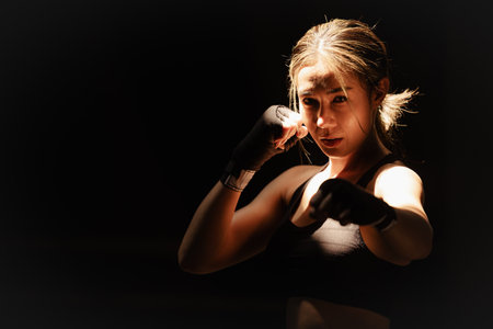 Muay thai, strong women fighter wrapped fist to Bare Knuckle traditional art of fighting Asian style kick boxing peopleの写真素材