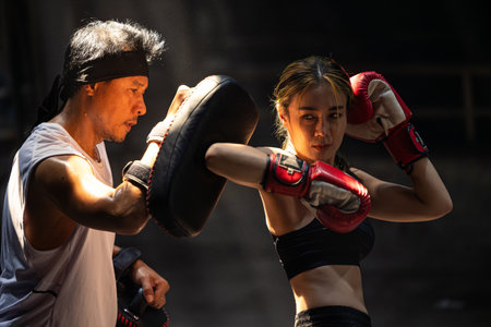 Muay Thai, Asian young women training Fighting kick boxing fighters fighting elbow action, Thai fight boxingの写真素材