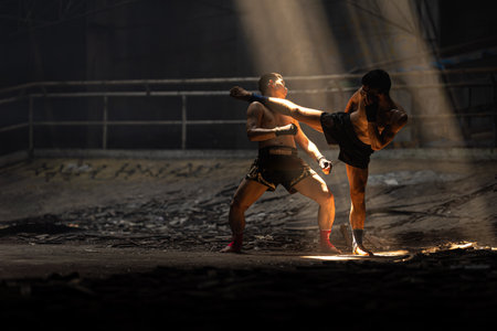 Muay Thai, Asian young male Bare Knuckle Fighting street kick boxing fighters fighting action, Thai fight boxing in dark old buildingの写真素材