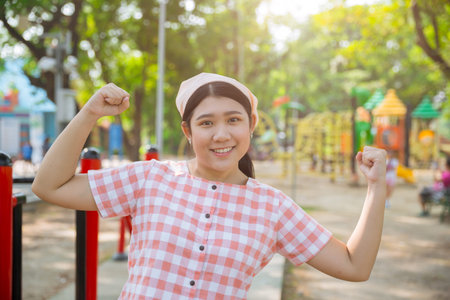 Cute young Asian healthy plump woman standing happy smiling at outdoor sport recreation green park