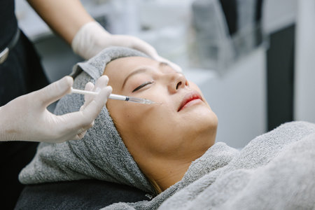 Beautician skin doctor injecting filler at woman face skin for facial treatment anti aging in beauty...