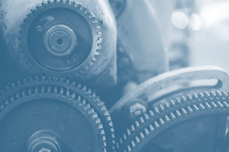 Gear industry background, Mechanical cog wheel in machine, Heavy industry machinery blue color tone
