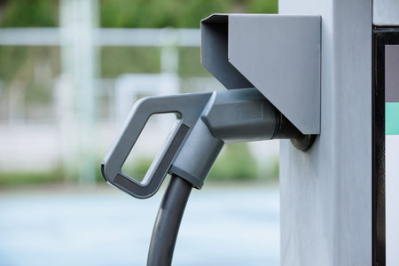 Closeup electric car charger head plug for charging EV car at ev charger station
