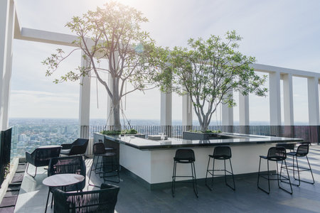 Rooftop pub and bar sky view, City skyline view balcony beautiful place of hotel roof top restaurant with chair and seat no bodyの写真素材