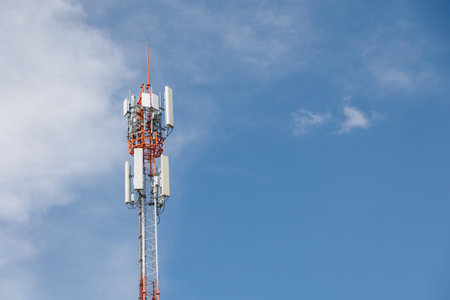 Communication towers on blue sky, 5G networks post. Network cell site. Omni direction digital data...