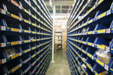 Blur parts storage room in industry factory warehouse store electronic parts and machine parts shelf for backgroundの写真素材