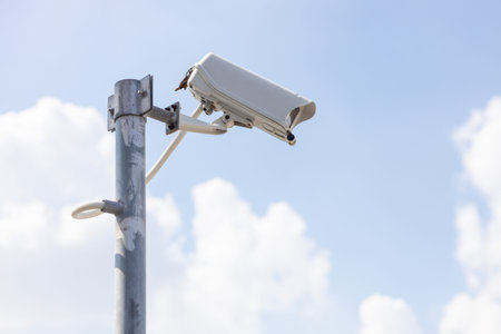 CCTV outdoor camera, building security guard. area safety surveillance cam with blue sky background