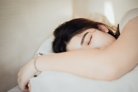 Women sleeping like a child, closeup shot white female sleep on the bed in the morningの写真素材