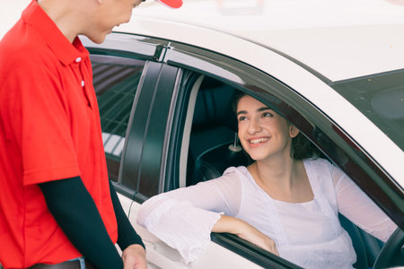 Happy car owner talking smiling for good service to gas station staff worker latin women car driver