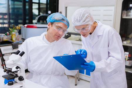 Scientist working talking discussion together at science lab, medical lab people working with...
