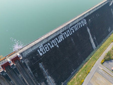 Dam in Thailand with low water level reserved in dry summer season, Thai text is name "Khun Dan Prakanchon Dam"の写真素材