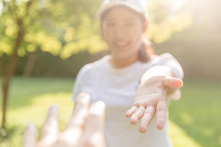 Girl teen smiling and reach her hand. Help Touch Care Support be a Good Friend with Love concept. Warm welcomeの写真素材