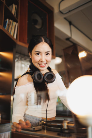 DJ Asian women young teen with music player, party sound entertainment happy smiling expressionの写真素材