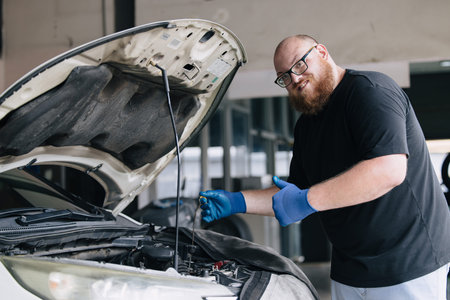 Portrait happy garage Mechanic worker in auto service center working service maintenance modern car with professional skill and safety uniform.