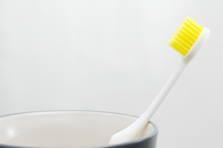 Toothbrush in cup on white backgroundの写真素材