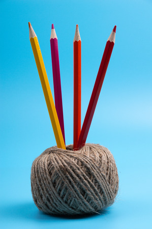 color pencils and string basket on blue backgroundの写真素材