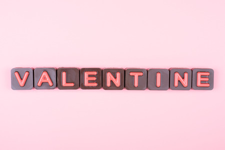 Valentine engraved in chocolate on colored backgroundの写真素材