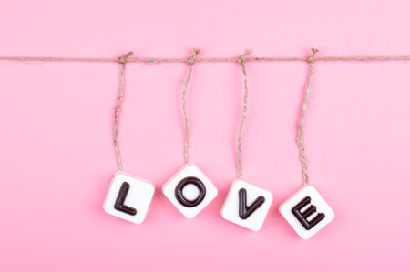 Love engraved in chocolate on colored backgroundの写真素材
