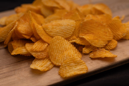 Bowl of crispy potato chips or crisps with salt isolated on white background, top viewの写真素材