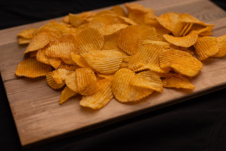 Bowl of crispy potato chips or crisps with salt isolated on white background, top viewの写真素材