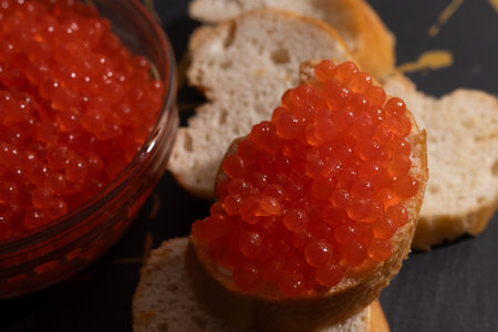 caviar in a plate sandwich with caviar salmon caviar close-up macro photo spoon caviar delicacy baguetteの写真素材
