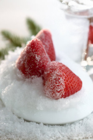 Frozen Strawberries on a Snowy Plate A Winter Dessertの写真素材