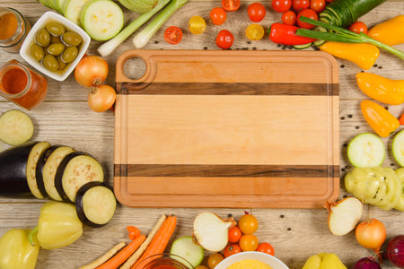 Cutting board in food vegetable frame. Space for textの写真素材