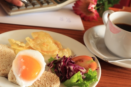 Breakfast coffee at workの写真素材