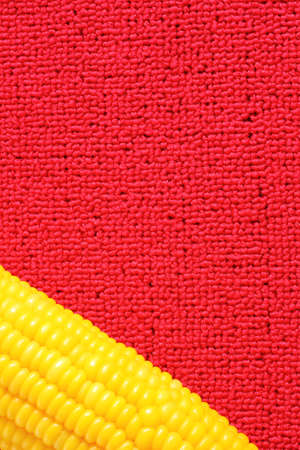 Sweet corn on  red background の写真素材