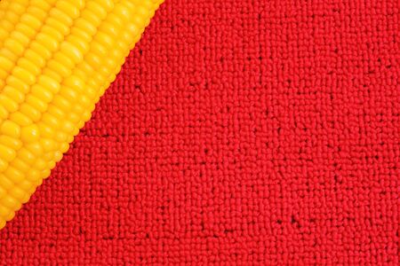Sweet corn on  red background の写真素材