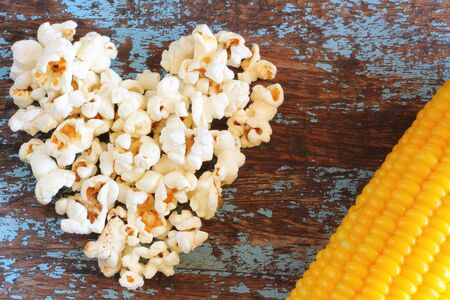 Heart popcorn on woodの写真素材