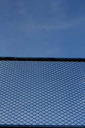 Mesh fence and skyの写真素材