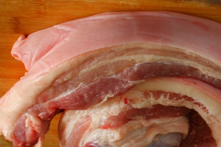 Streaky pork on cutting board の写真素材