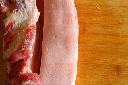 Streaky pork on cutting board の写真素材