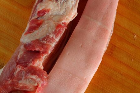 Streaky pork on cutting board の写真素材