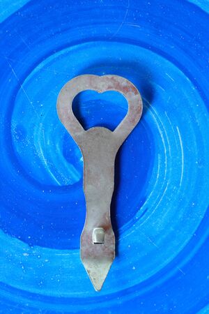 Bottle opener on blue backgroundの写真素材