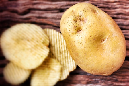 Close up of potato chips and fresh potatoの写真素材