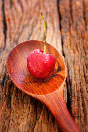 Fresh cherries on the wood backgroundの写真素材