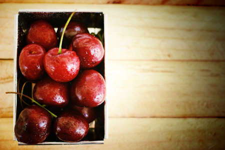 Fresh cherries on the wood backgroundの写真素材