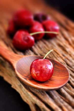 Fresh cherries on the wood backgroundの写真素材