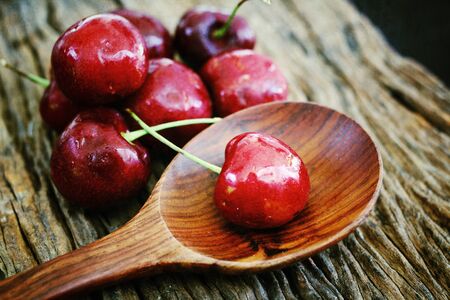 Fresh cherries on the wood backgroundの写真素材