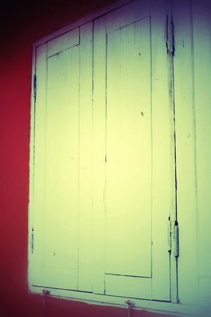 Vintage style window on orange wallの写真素材